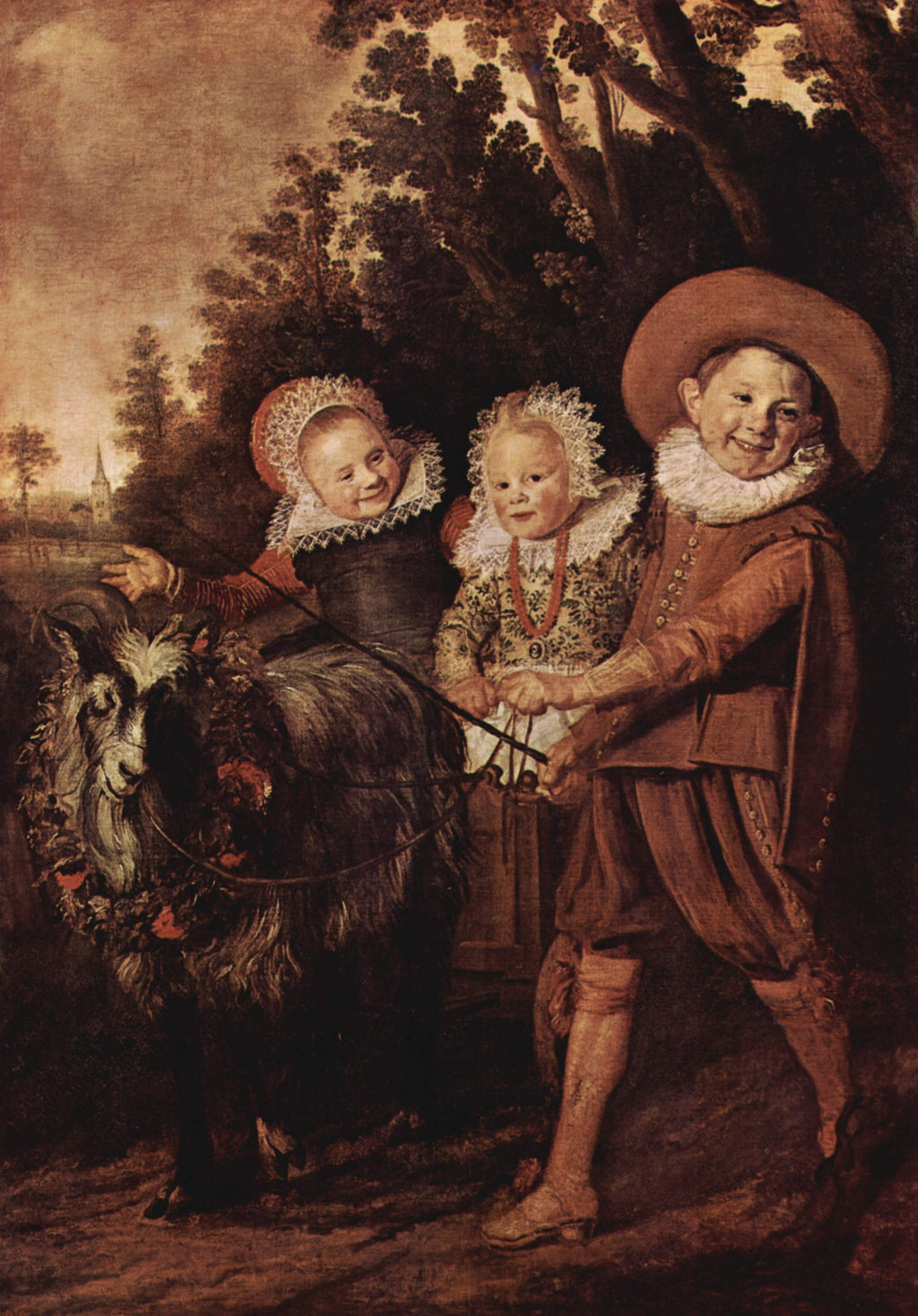 Tres niños con un carrito de cabra